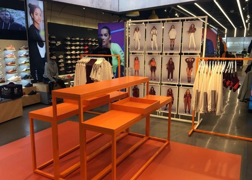 orange clothing store display assembled by professional retail fixture installer