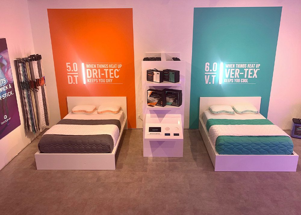 view of two beds on display in a retail bedding store showroom