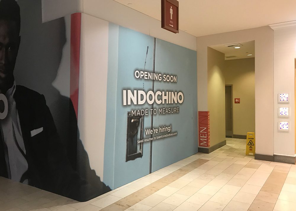 wall wrap installation showing that a retail store in a mall is opening soon